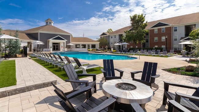 Relax poolside with comfortable chairs and table seating for entertaining and lounging, professionally operated by Highlands Vista Group.