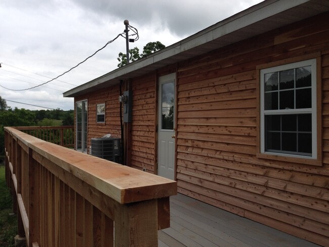 Deck with Sliding glass doors on Left and side door on Right