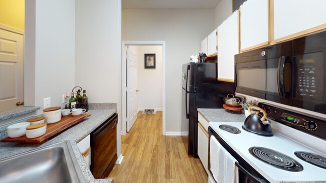 The kitchen includes a dishwasher, built-in microwave, and easy access to your in-unit laundry.