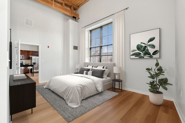 Bright loft-style bedroom with large windows and modern industrial design