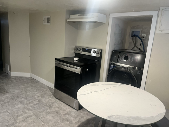 Eat-in kitchen with newly installed washer/dryer combo - 3621 Orchard Ave Apartments Unit Downstairs