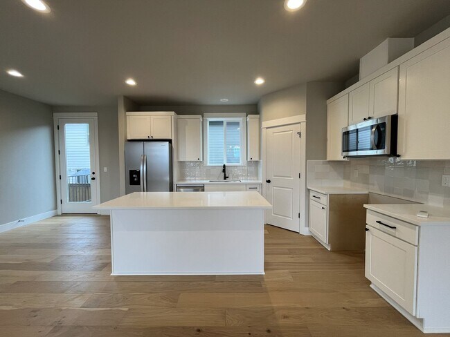 Photo - Brand New Spacious and Light-Filled Condo Offering an Open Layout, Island Kitchen, and Outdoor Deck