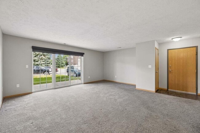 A bright, open living area with generous natural light creates a welcoming space to relax, gather, and feel right at home. - Williamsburg Park Apartments