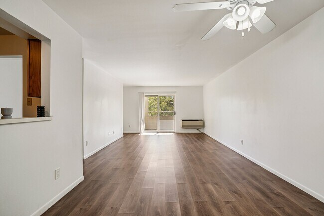 Comfortable spaces feature ceiling fans for year-round comfort and attractive wood flooring, professionally operated by Highlands Vista Group.