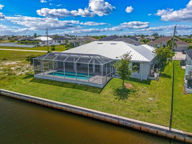 Photo - NOW AVAILABLE - Gorgeous Pool Home ~ NW Cape ~ 3 Car Garage ~ On Canal!