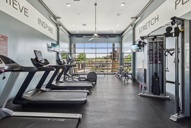 Large Fitness Center with Treadmills, Free Weights & Much More  at Overlook at Stone Oak Park Apartments, San Antonio - Overlook at Stone Oak Park Apartments
