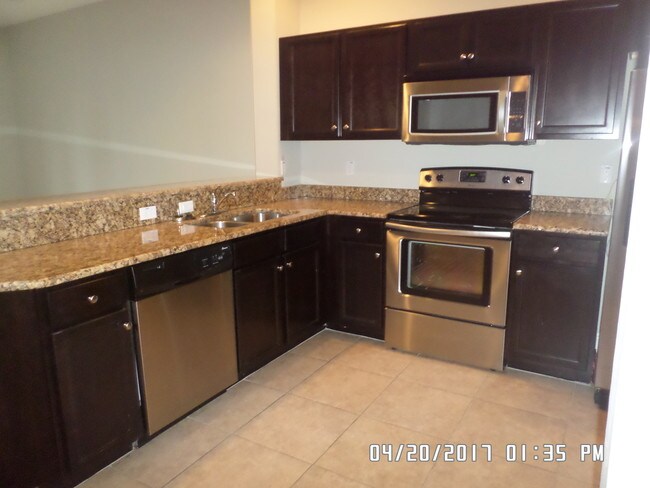 Upgraded kitchens with granite - The Residences at Page Park
