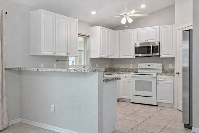 Photo - Spacious Three-Bedroom Home with Open Floor Plan, Large Yard & Screened Patio