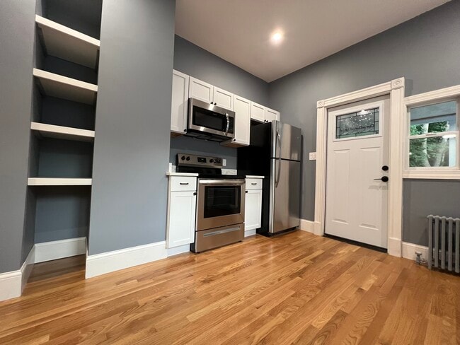 Eat-in kitchen with granite countertops and stainless steel appliances - 111 Falcon St Unit 2