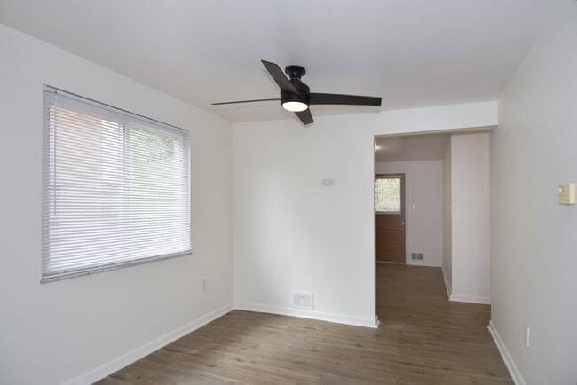 Separate dining room is freshly painted with all-new luxury vinyl plank flooring, new mini-blinds, a