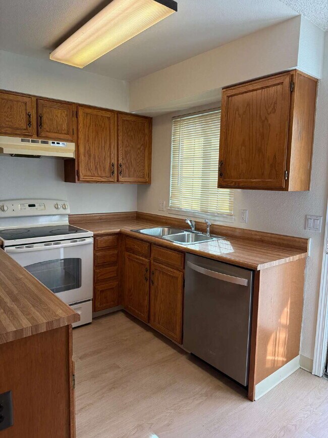 Photo - Cozy 2 Bed, 1.5 Bath Townhouse with Fireplace + Community Pool + Reserved Parking Space! Unit A
