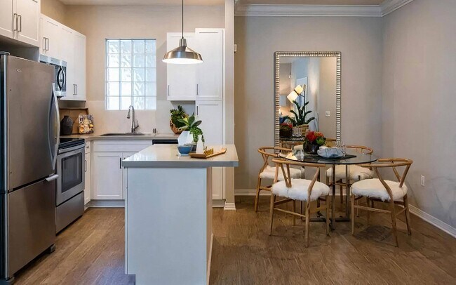 Island Kitchen with Breakfast Bar and Adjacent Dining Space - Amerige Pointe