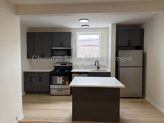 Building Photo - 7833 S Colfax Ave Unit 3s