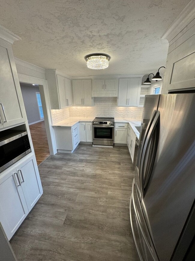 Photo - Fully Renovated 4 Bed Home w/ Fenced Backyard, W/D's in Unit.