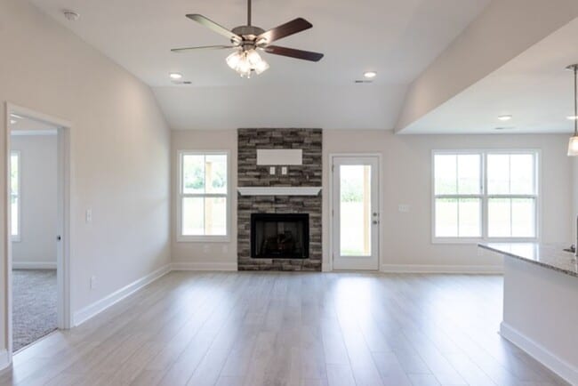 Photo - Modern Living Redefined with Stone Fireplace, Gray Cabinetry, Spa Inspired Primary Suite and Cove...