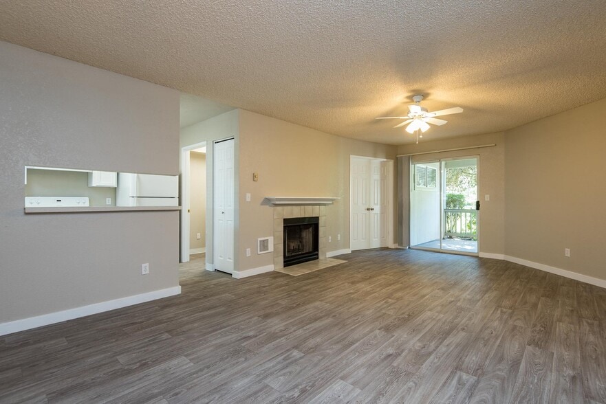 Two Bedroom w/ Den | Living Room with Fireplace and Patio