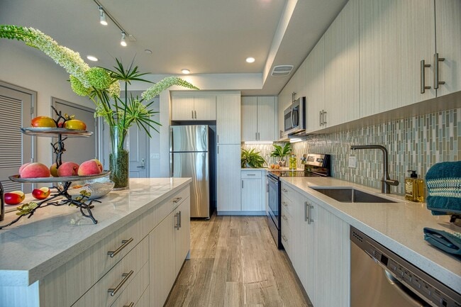 Light-filled kitchen with granite counters, energy-efficient appliances, and a clean, streamlined design.