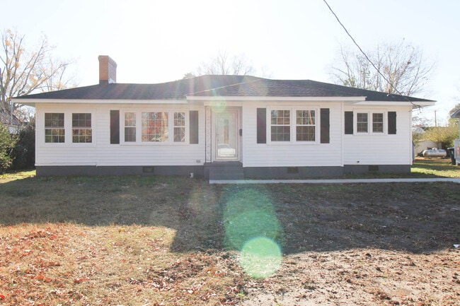 Front view with driveway and sidewalk