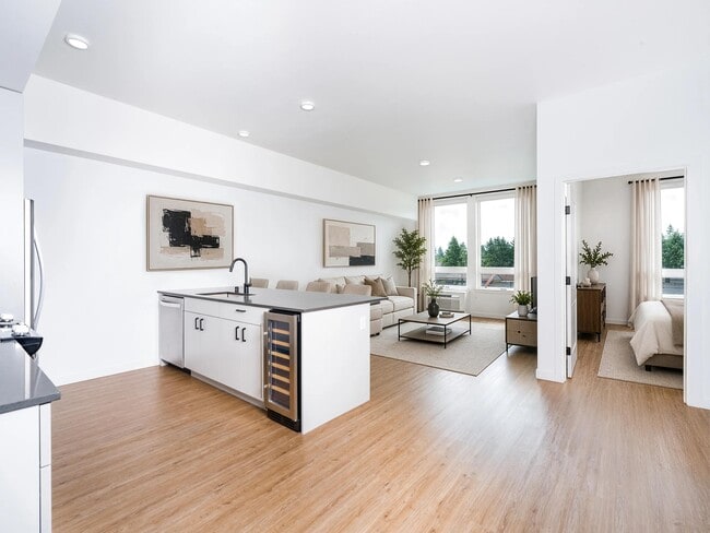Open-concept living with a spacious kitchen island, integrated wine storage, and seamless flow between dining, lounge, and private bedroom areas.