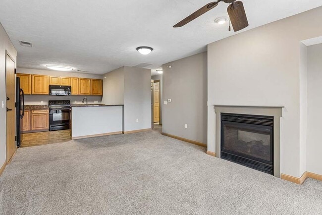 A cozy fireplace, open-concept layout, and warm finishes create a space that feels effortlessly like home.