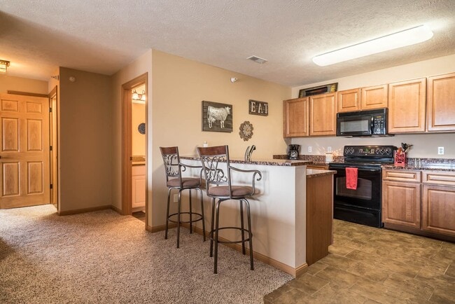 Enjoy an open-concept kitchen and dining area, perfect for casual meals or entertaining guests. - Grand Legacy