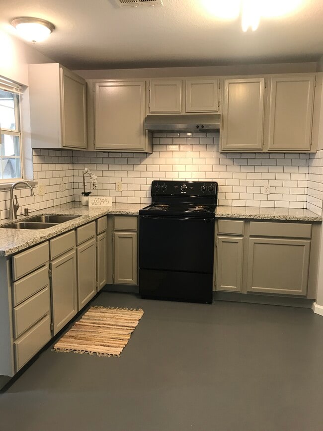 Upgraded kitchen with new counters and stylish new backsplash.