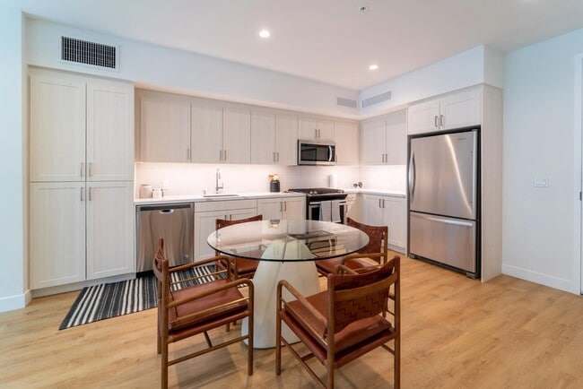 Kitchen with bright cabinetry, stainless steel appliances, and generous storage, paired with a dedicated dining area for everyday meals and gathering.