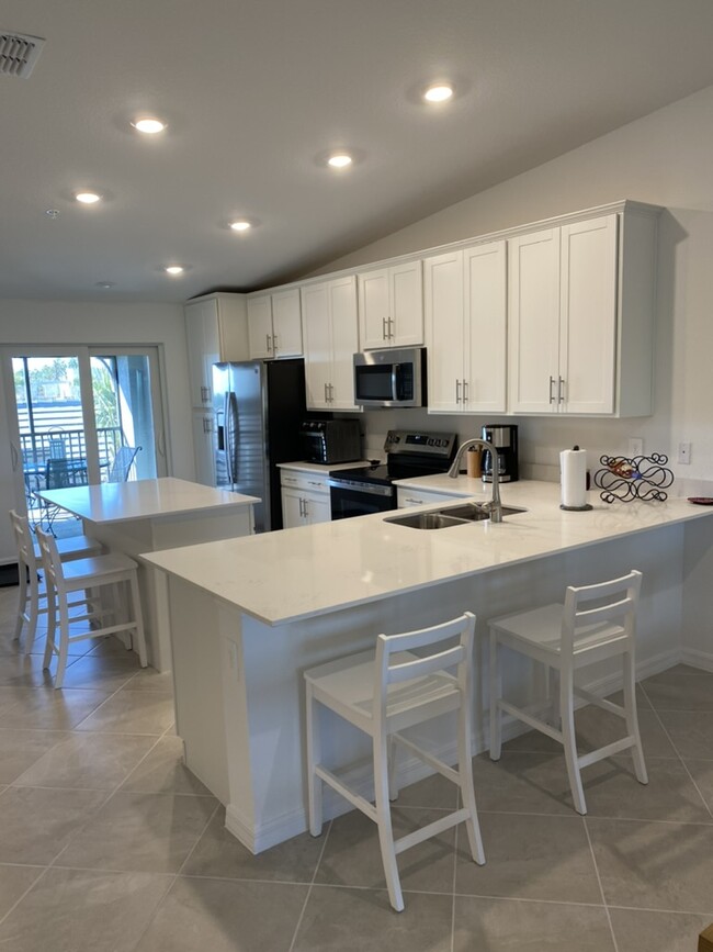 Kitchen with Sliders to Front Lanai - 17475 Opal Sand Dr Condo Unit 207