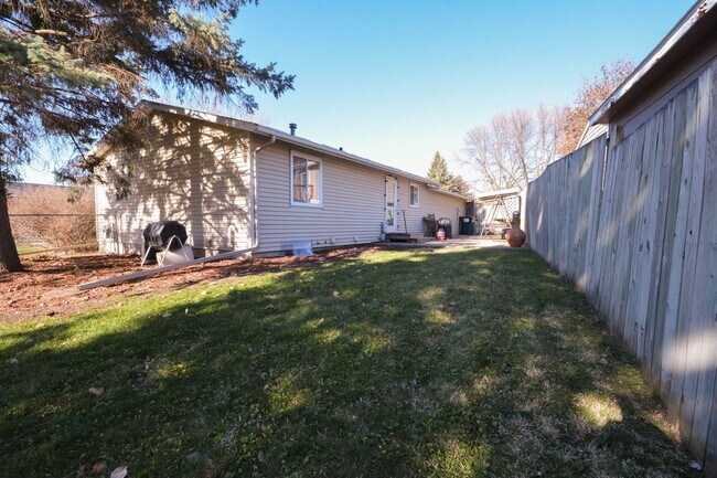 Photo - Ranch-style home with great fenced yard & patio!