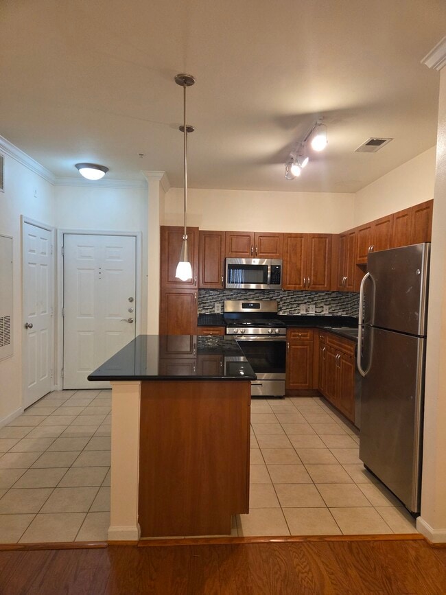Open kitchen and large island with storage - 12945 Centre Park Cir Unit 105
