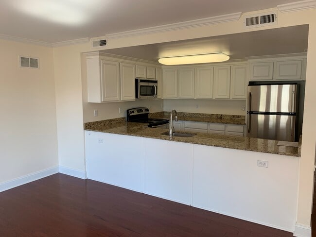 Kitchen opens to living space - Ridgefield Commons