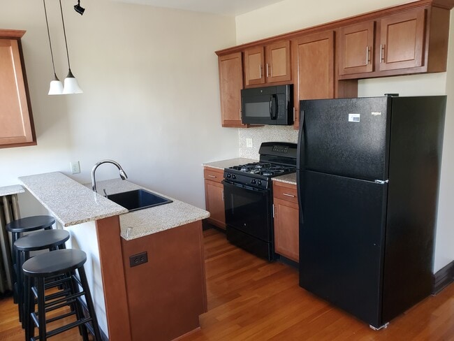 Brand new kitchen, breakfast bar with stools - 534 Yates St Apartments