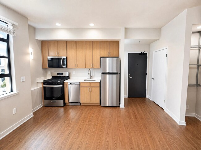 Open-concept dining and kitchen with updated lighting.
