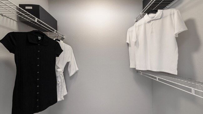 This spacious walk-in closet offers ample storage and organization options, perfect for keeping your wardrobe neat and accessible.