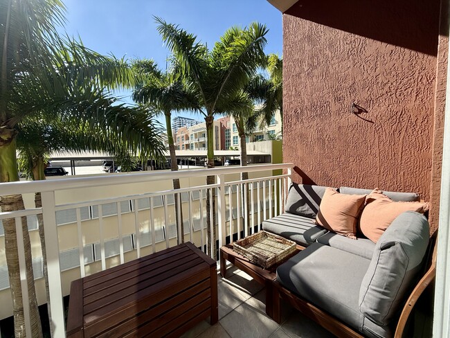 Furnished balcony with high table and lounge - 2001 Biscayne Blvd Condo Unit 2403