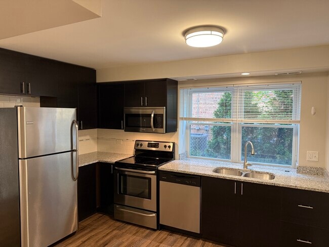 New kitchen with SS appliances and Granit cou - 6626 W Devon Ave Unit 1