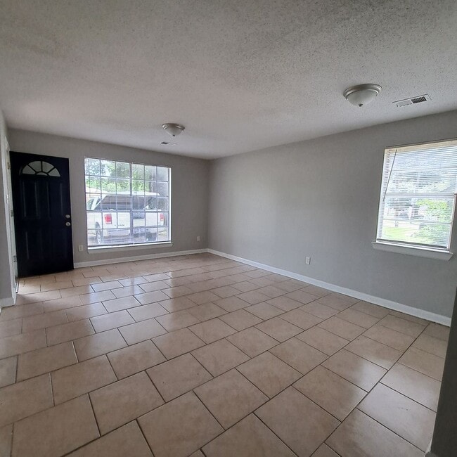 Photo - This 2BR/1BA includes a nice-sized living area, an ample kitchen, a fenced-in