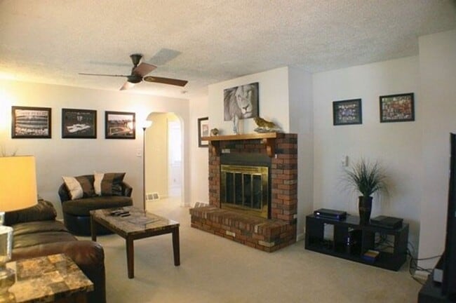 Photo - Corner Lot Charm: Spacious 3-Bed Home with Fireplace and Prime Location