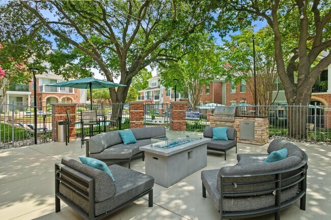 Outdoor entertainment space that's outfitted with a grilling station and abundant seating. - Windsor at Legacy
