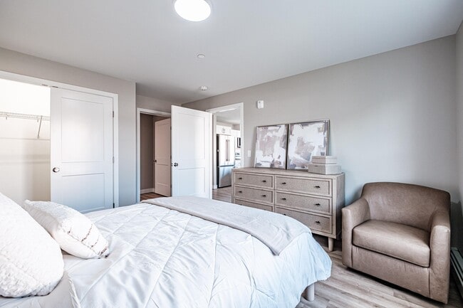 Relax in a spacious primary bedroom complete with a walk-in closet and private ensuite bathroom, offering comfort, convenience, and contemporary style.