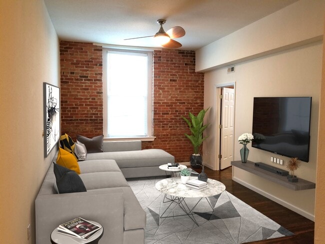 Exposed brick wall and large window in livingroom. - 304 N Front St Condo Unit 304-D North Front Street