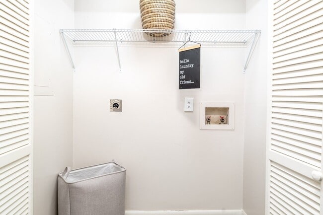Convenient in-home laundry closet with washer and dryer connections available at Sugar Creek Apartments in Winston-Salem, NC.
