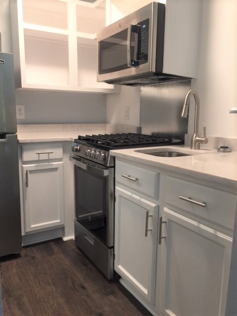 This studio kitchen has granite countertops and a stainless steel sink, as well as cubbies, cabinets and drawers for storage. - 3819 Gallatin Pike Apartments Unit 72