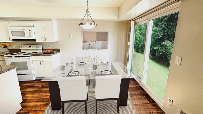 Modern white appliances and cabinetry in large well-designed kitchen - Foxpointe Townhomes
