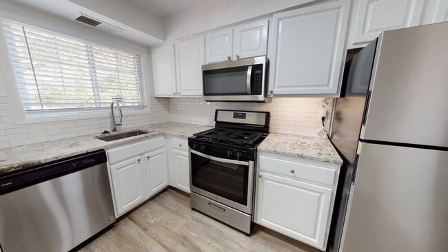 Cocina renovada con gabinetes estilo shaker y manijas de cromo cepillado
