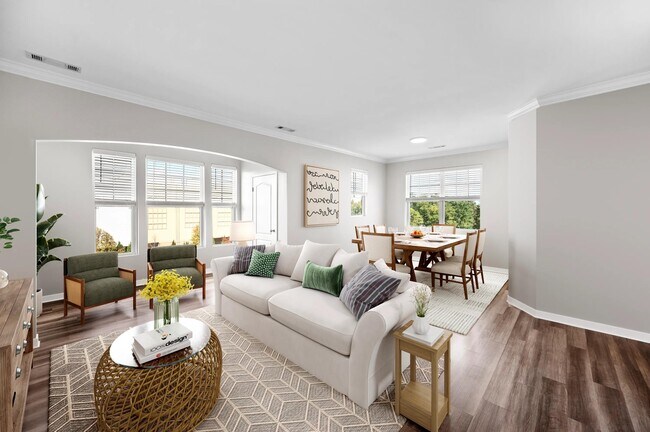 Sunlit living and dining area with expansive windows, warm flooring, and an open layout that brings comfort and connection to everyday living.