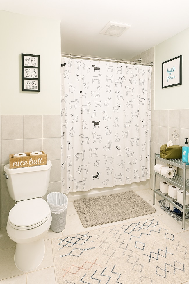 Lower-level bathroom with a full tub, located just off the kitchen with a vented exhaust fan. - 56 Jefferson Ave Unit #1