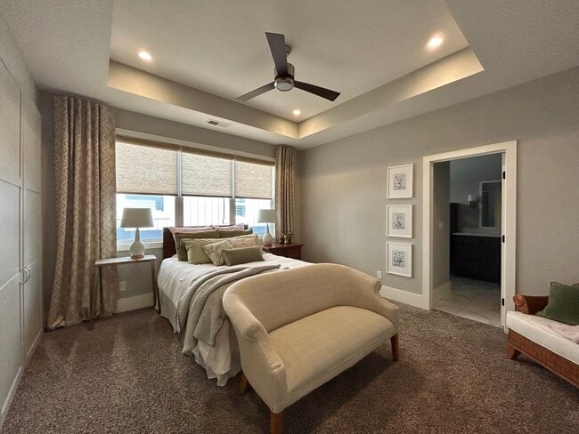 Primary bedroom with ensuite bathroom and separate his and her closets - 405 E 32nd Ave