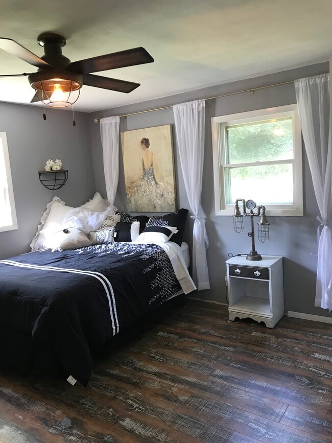 Second bedroom. Flooring pictured runs throughout this entire apartment villa. Completely remodeled, brand new mattress and luxurious bedding. - 502 Crab Apple Ct Unit 1100 square foot fully furnished two bedroom