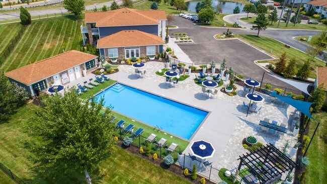 Immerse yourself in the luxurious resort-style pool and sprawling sundeck, a captivating oasis for residents to unwind and relish moments of leisure. - Lenox West Luxury Apartments